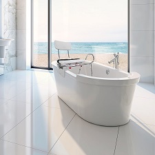 A white shower transfer bench that is mounted on the edge of a bathtub